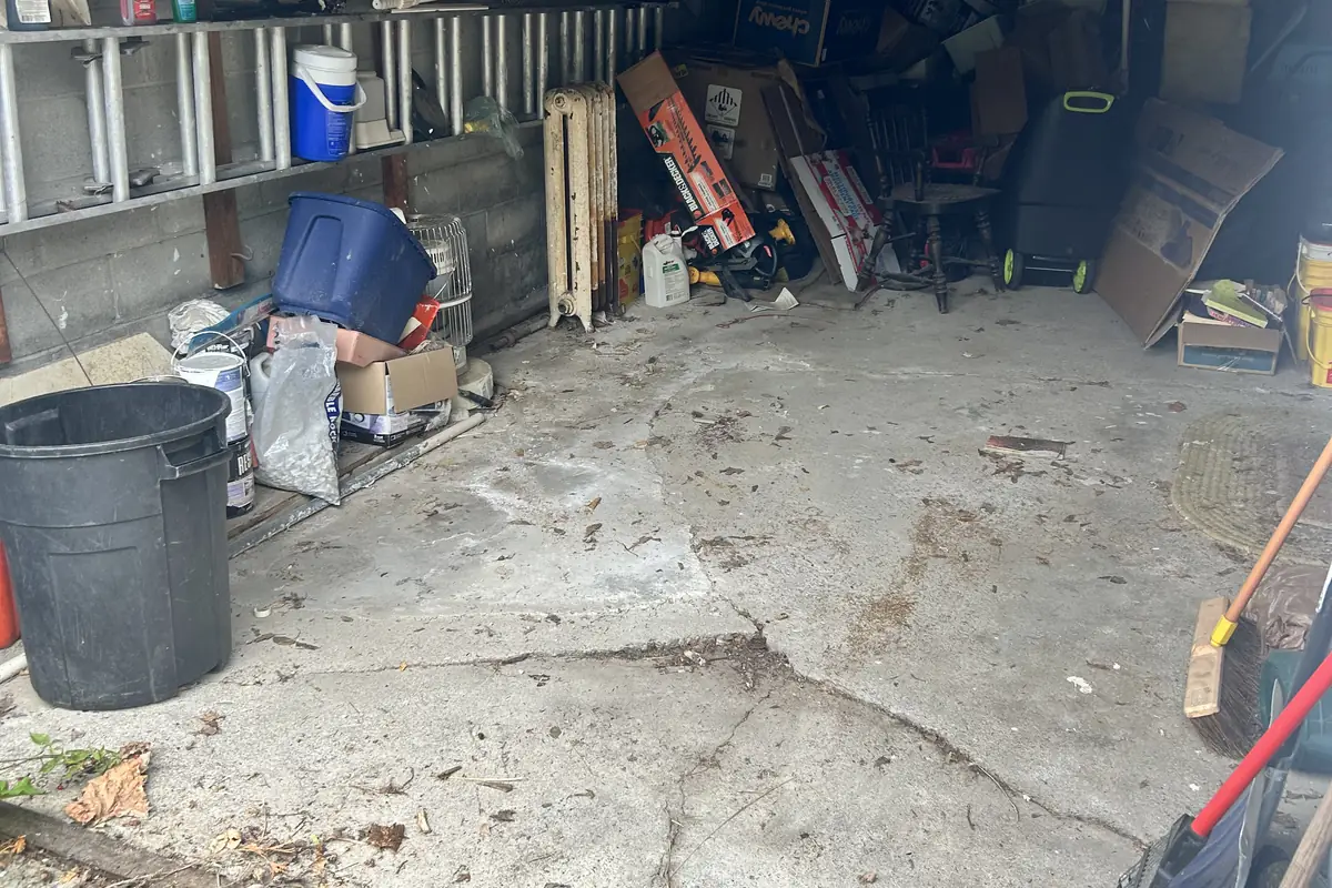 The same garage after the Brute Waste cleanout with the concrete floor clear and only a few items left along the wall