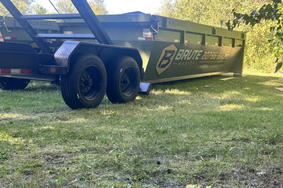Close view of the hydraulic hoist frame and wheels on a Brute Waste gooseneck dumpster trailer